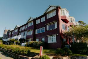 a red building with white windows on a street at Mountain Heritage Hotel in Katoomba