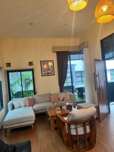a living room with a couch and a table at Villa indah sudungdewo in Wonosobo