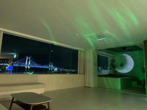 an empty room with a view of the aurora in the sky at 광안사계스테이 GwanganSagyeStay in Busan +73 photos