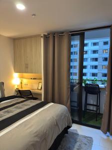 a bedroom with a bed and a balcony with a view at Moderno y nuevo apartamento en Lirios de Miraflores in Tegucigalpa
