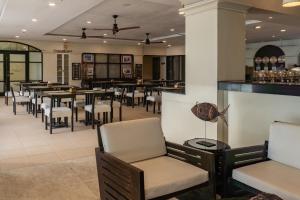 a restaurant with tables and chairs and a bar at Boracay Sands Hotel in Boracay +4 photos