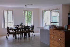a kitchen and dining room with a table and chairs at Sweet Home Property in Perth
