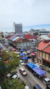 a city with cars parked in a parking lot at KITA Studio - Kota Bharu City Point in Kota Bharu