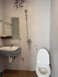 a bathroom with a toilet and a sink at Hoang Kim Ha Giang Hotel in Ha Giang +30 photos