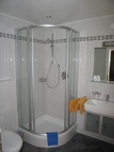 a shower in a bathroom with a toilet and a sink at Pension Appartments Christoph in Westendorf