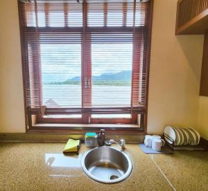 a sink in a bathroom with a large window at Sea Villa Langkawi in Kampung Padang Masirat +37 photos