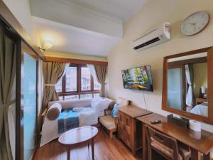 a living room with a couch and a mirror at Sea Villa Langkawi in Kampung Padang Masirat
