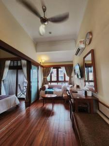 a living room with a couch and a ceiling fan at Sea Villa Langkawi in Kampung Padang Masirat