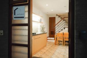 a kitchen and dining room with a table and stairs at Whole House with 3 Bedrooms in Hoan Kiem - 7mins to Hoan Kiem lake - FREE launchdry & breakfast in Hanoi