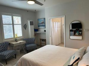 a bedroom with a bed and a desk and a mirror at Sandy Toes Studio in Oceano