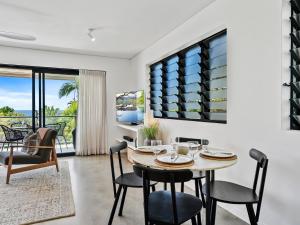 a dining room with a table and chairs with a view at Oceanbreeze - Sunshine Beach Ocean Views in Sunshine Beach