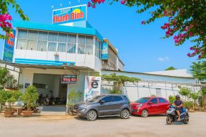 a man on a scooter in front of a car dealership at Thanh Bình Hostel in Can Tho