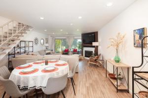 a dining room and living room with a table and chairs at Blacklake Resort Vacation Rental Nestled on the 9t in Los Berros +13 photos