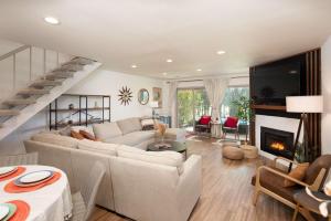 a living room with a couch and a fireplace at Blacklake Resort Vacation Rental Nestled on the 9t in Los Berros