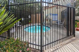 a metal fence with a small pool in it at Lagoon View and Ocean Breeze in Oceano