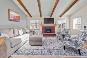 a living room with a couch and a fireplace at The Bay Escape in Cuesta-by-the-Sea