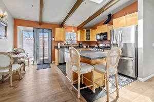 a kitchen with a table and chairs and a refrigerator at The Bay Escape in Cuesta-by-the-Sea