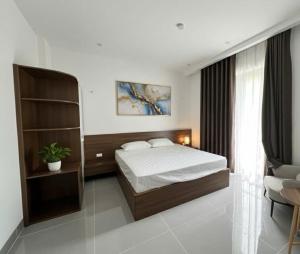 a bedroom with a bed and a book shelf at Tea hotel by Chiến Hảo in Ha Giang +41 photos