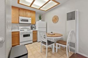 a kitchen with a table and a white refrigerator at Eye Sea in Oceano