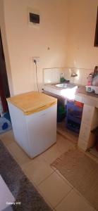 a kitchen with a sink and a white cabinet at Smooth Landing in Ukunda