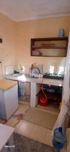 a kitchen with a table and a counter top at Smooth Landing in Ukunda