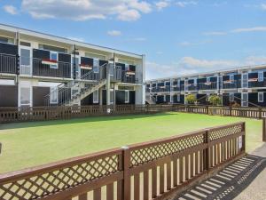 a large lawn in front of a building at Holiday home on a holiday park in Glesborg in Glesborg