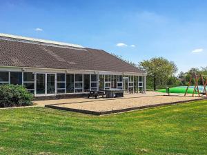 a building with a park with a playground at 6 person holiday home on a holiday park in Hemmet in Hemmet