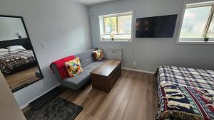 a small room with a couch and a bed at Mt Spokane ski condo in Mead