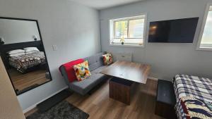 a small room with a couch and a table at Mt Spokane ski condo in Mead +9 photos