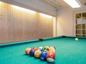 a pool table with a bunch of balls on it at 4 person holiday home on a holiday park in Faaborg in Fåborg +57 photos