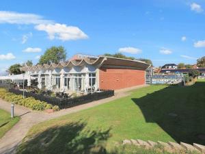 a building with a lawn in front of it at 6 person holiday home on a holiday park in Faaborg in Fåborg