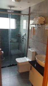 a bathroom with a shower and a toilet and a sink at Munnar Peak Paradise in Anachal