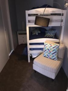 a bunk bed and a chair in a room at Spacious Modular Rental on Huge Horse and Cattle Farm near Charlottesville, Virginia in Gordonsville