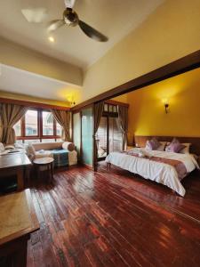 a large bedroom with two beds and a desk at Sea Villa Langkawi in Kampung Padang Masirat