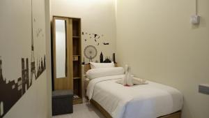 a bedroom with two beds with white sheets at The One Residence Tanah Abang in Jakarta +22 photos