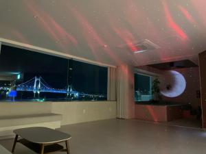 a living room with a view of a bridge at 광안사계스테이 GwanganSagyeStay in Busan