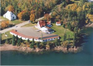 a large house on an island in the water at Redclyffe Shore Motor Inn in Robbinston