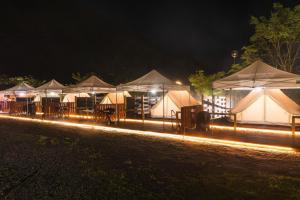 a row of tents with lights at night at SPRINGS VILLAGE Ashigara Tanzawa Onsen Resort & Gl - Vacation STAY 41908v in Hata