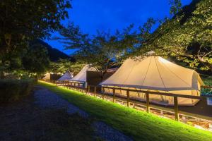 a row of tents in a field at night at SPRINGS VILLAGE Ashigara Tanzawa Onsen Resort & Gl - Vacation STAY 41906v in Hata