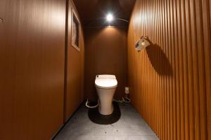 a bathroom with a toilet in a stall with a light at SPRINGS VILLAGE Ashigara Tanzawa Onsen Resort & Gl - Vacation STAY 41907v in Hata