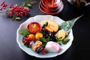 a plate of food with fruit and vegetables on a table at SPRINGS VILLAGE Ashigara Tanzawa Onsen Resort & Gl - Vacation STAY 41914v in Hata