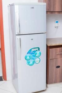 een witte koelkast in een keuken met een sticker erop bij Beach View Holiday Home in Mombasa