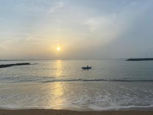 a person in a boat in the ocean at sunset at Seavora Tangalle in Tangalle