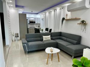 a living room with a couch and a table at Rich Villa Guesthouse in Bayamon