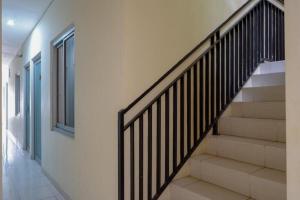 a staircase in a house with a stair case at Urbanview Hotel Double Tree near RSUD Margono Purwokerto in Purwokerto