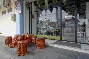 a store with a wooden bench in front of a store at Urbanview Hotel Double Tree near RSUD Margono Purwokerto in Purwokerto