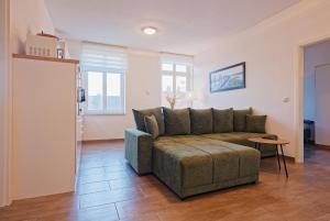 a living room with a couch and a table at Modern family apartment in Bamberg in Bamberg
