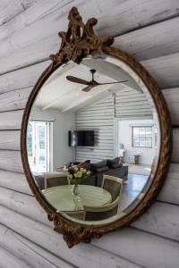a mirror on a wall with a table in a living room at Webbs Creek Farm Retreat in Wisemans Ferry