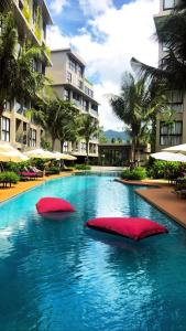 two red pillows in a swimming pool in a building at Diamond condo apart Bangtao beach in Bang Tao Beach
