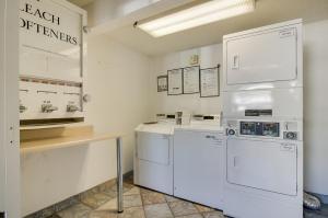 a kitchen with white appliances and a counter at Motel 6-Tacoma, WA - South in Tacoma